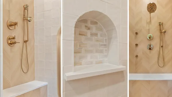 Shower with brass fixtures, an arched niche and body sprays