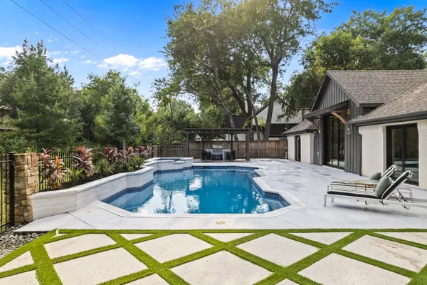 Pool and patio, with grass between the pavers