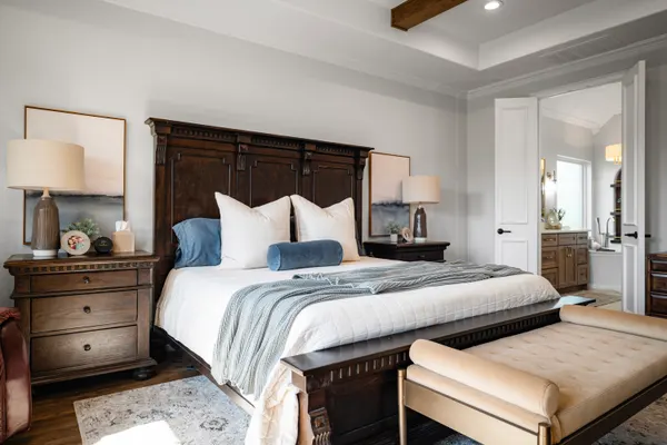 Primary bedroom with a carved wood bed