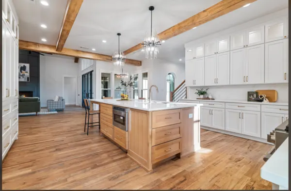 Wood kitchen island open to the living room and its fireplace