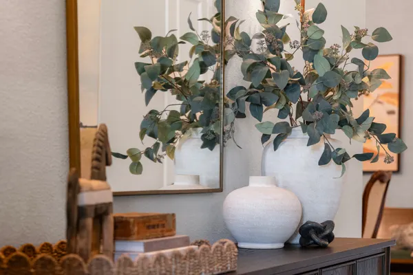 Eucalyptus and white vases on the entry console