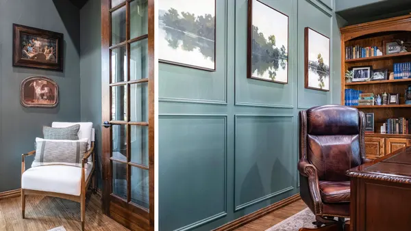 Study with a teal paneled wall, glass doors and built-in bookshelves