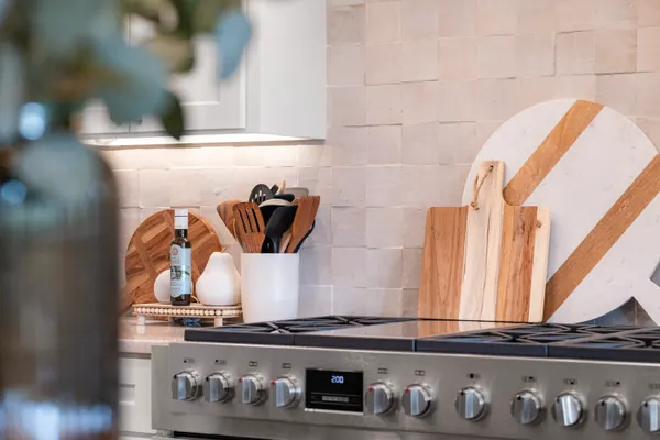 Professional-style range against a cream tile backsplash