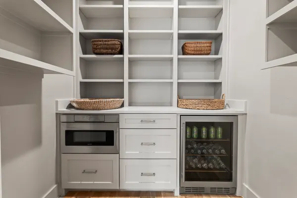 Coffee bar with open shelves, a microwave drawer and a wine fridge