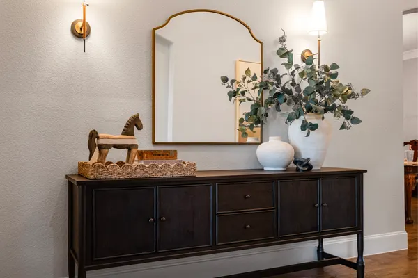 Console under an arched mirror in the entry