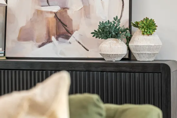 Art and pottery on a black fluted console