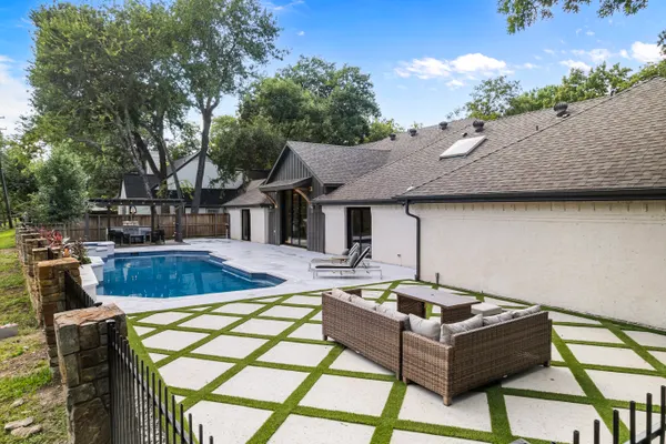 Backyard with a pool, a turf-grid patio and outdoor seating
