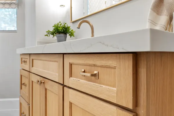 White oak vanity drawers with brass pulls