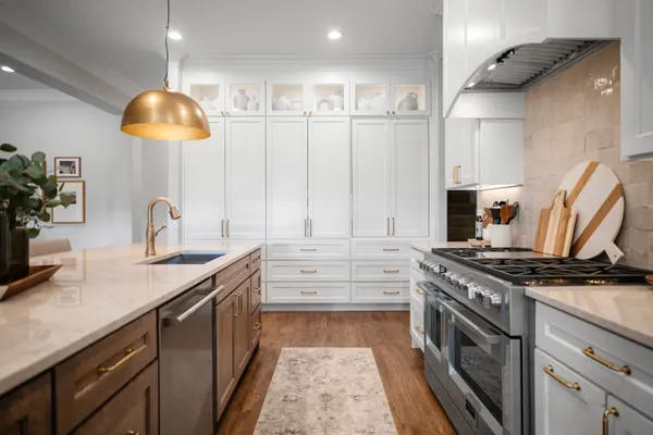 White cabinetry to the ceiling beside a professional-style range