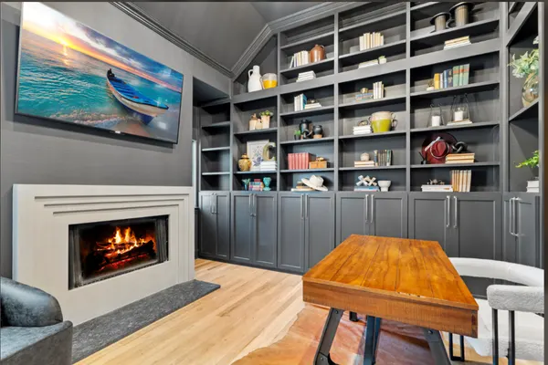Study with charcoal built-in shelves, the fireplace and a wood desk