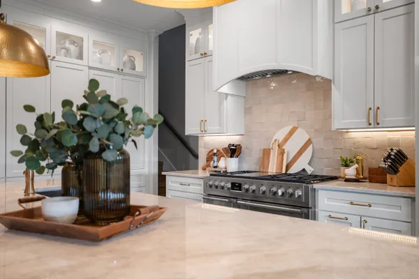 Island countertop, with the range and the cream tile backsplash beyond