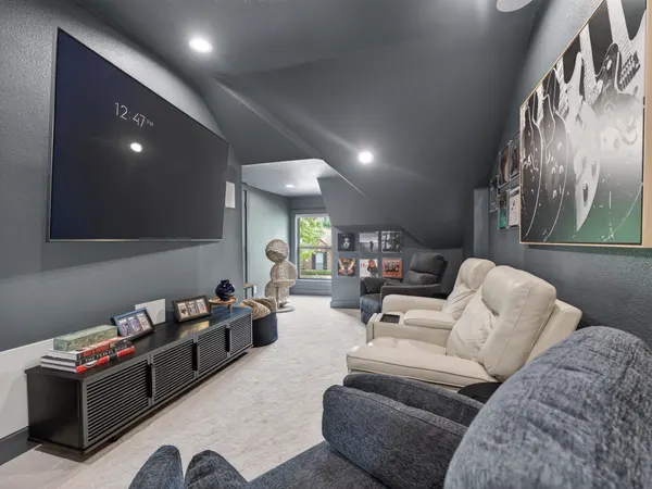 Media room with charcoal walls and a sloped charcoal ceiling