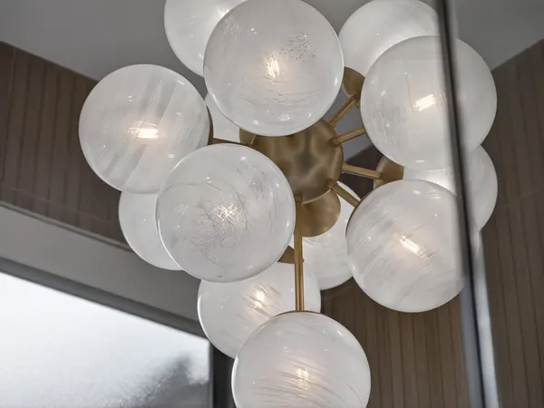 Glass globe chandelier with a brass center